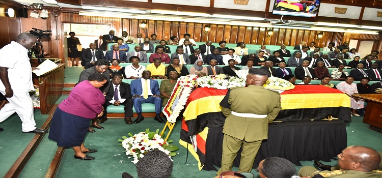 Premier Nabbanja pays her respects after laying a wreath on the coffin containing the body of Engola