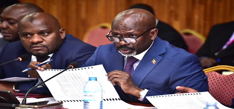 Kasilo County MP, Hon. Elijah Okupa (R) peruses one of the documents during the meeting